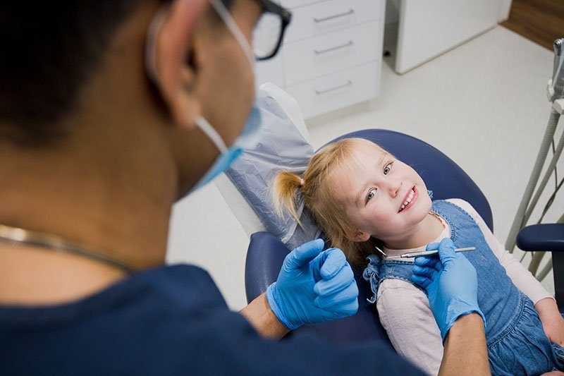 dr nishant with little girl patient cosmetic dentist warrnambool